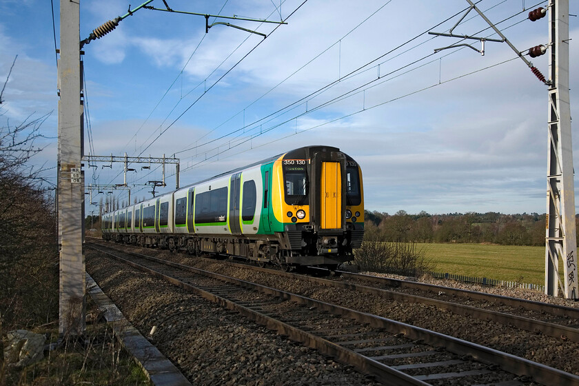 350130, LM 11.14 Birmingham New Street-London Euston, Wilson's Crossing 
 In crisp winter light London Midland's 350130 approaches Northampton working the 11.14 Birmingham New Street to Euston service. The train is passing Wilson's Crossing, a well-known and popular foot crossing both with dog walkers and railway photographers alike! 
 Keywords: 350130 11.14 Birmingham New Street-London Euston Wilson's Crossing London Midland Desiro