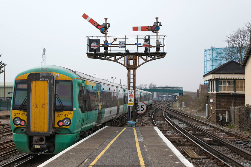 377474, SN 16.54 Littlehampton-Portsmouth & Southsea, Littlehampton station 
 Like nearby Bognor Regis, Littlehampton remains a bastion of mechanical signalling. Taking away the relatively modern Electrostar, the contemporary signage and the telecommunications mast this scene could have been taken at any time within the last one hundred years with the superb station up starters and the tiny LBSE 1886 signal box. 377474 leaves the station with the 16.54 service to Portsmouth and Southsea. 
 Keywords: 377474 16.54 Littlehampton-Portsmouth Southsea Littlehampton station Southern Electrostar