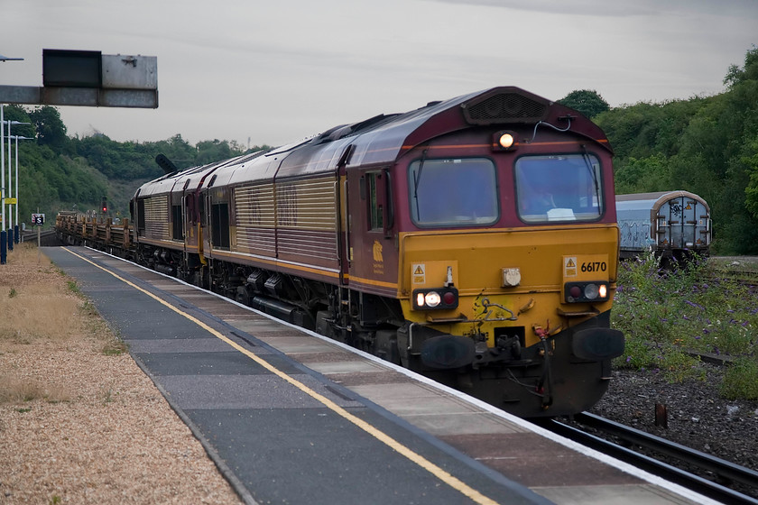 66170 & 66133, 10.17 Scunthorpe Trent-Eastleigh East Yard (6X01), Micheldever station 
 By the time Andy and I reached Micheldever the thunder and lightening sweeping in from the south was virtually on us, but not quite. It created a very strange light that can be seen in this picture. 66170 and 66133 head south through the station with the 10.17 Scunthorpe to Eastleigh track train. 
 Keywords: 66170 66133 10.17 Scunthorpe Trent-Eastleigh East Yard 6X01 Micheldever station