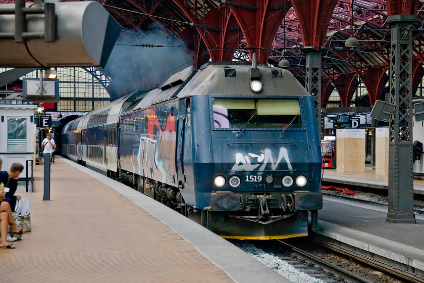 1519, 18.04 sterport-Ringsted, Copenhagen Central station 
 Class ME 1519 still appears to be accelerating, judging by the exhaust, as it enters Copenhagen Central from the series of short tunnels to the north of the station. The graffiti daubed locomotive is leading the 18.04 sterport to Ringsted working a town of some twenty-three thousand people in the centre of the island of Zealand forty miles from Copenhagen. 
 Keywords: 1519 18.04 sterport-Ringsted Copenhagen Central station DSB Class ME