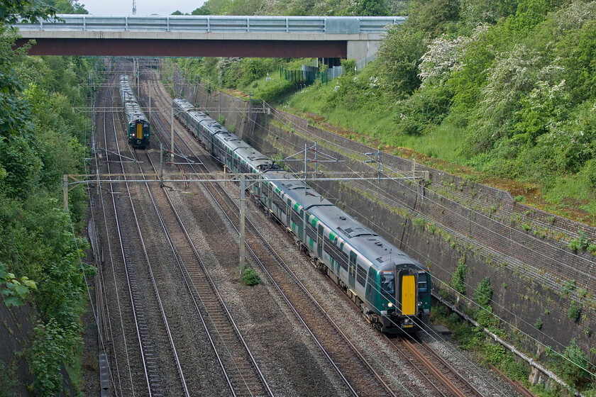 350129, LN 14.34 Crewe-London Euston (1U34, 10L) & 350115 & 350102, LN 14.36 Birmingham New Street-London Euston (1Y48, 1L), Roade cutting 
 The race is on! Two London Northwestern Desiros take each other on in Roade cutting both heading for Euston. To the right 350115 and 350102 work the 1Y48 14.36 from Birmingham New Street whilst to the left 350129 works the 14.34 from Crewe. 
 Keywords: 350129 14.34 Crewe-London Euston 1U34 350115 350102 14.36 Birmingham New Street-London Euston 1Y48 Roade cutting London Northwestern Desiro