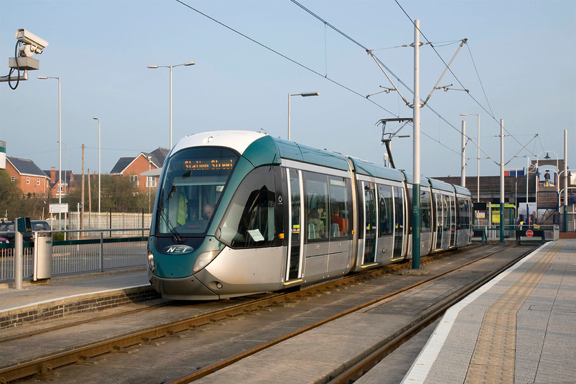 220, (NET) 07.35-Hucknall-Station Square, Hucknall station 
 One of Nottingham Express Transit's trams, 220, waits to leave Hucknall station with the 07.35 to Station Square. Hucknall's NET station is the most northerly point of the tram network that commenced operations in 2004. Adjacent to my immediate right is the Network Rail station. 
 Keywords: 220 NET 07.35-Hucknall-Station Square Hucknall station