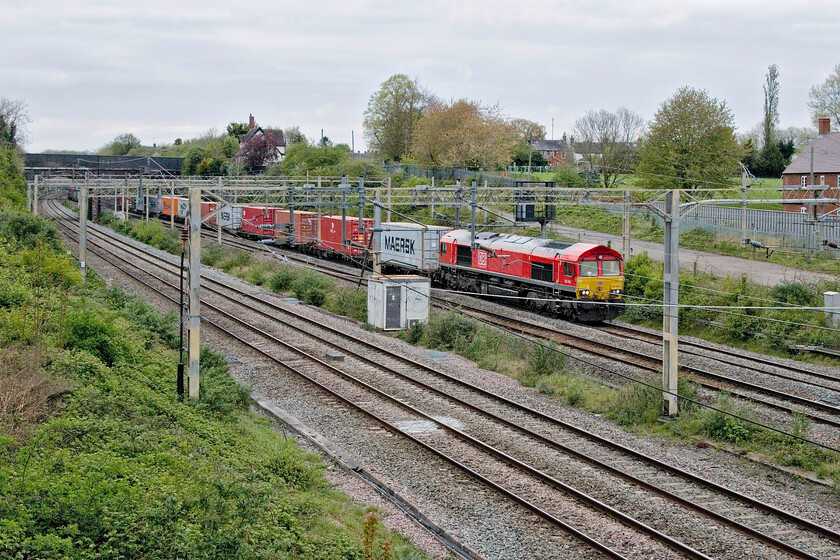 66244, 13.20 Trafford Park-London Gateway (4L56, RT), site of Roade station 
 My second 'grab' shot of the afternoon has not been quite so successful as the first (see previous picture but one). This one caught me out as I was returning from the garage having bought five litres of fuel for the lawnmower! It would not have made the cut but for it being of 66244 that is a photographic cop. The DB Cargo locomotive is leading the daily 4L56 13.20 Trafford Park to London Gateway service through the Northamptonshire village of Roade. 
 Keywords: 66244 13.20 Trafford Park-London Gateway 4L56 site of Roade station DB Cargo