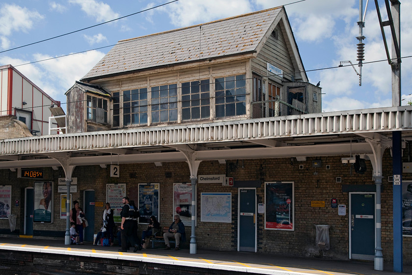 Disused Chelmsford signal box (GE, 1885) 
 This is a picture that caused much consternation! Notice the two security operatives on the platform, they took a particular dislike to Andy and I taking pictures on the station. This was despite that we had been permitted access by Greater Anglia staff at the gateline to do exactly that. I had the all too common 'you can't take pictures here - yes, I can actually' conversation across the platforms with them then radioing their control. Either way, it's good to see that Chelmsford's 1885 Great Eastern signal box is still intact in its lofty position above the station roof. Even more lofty when you realise that the station itself is elevated above street level. 
 Keywords: Chelmsford signal box