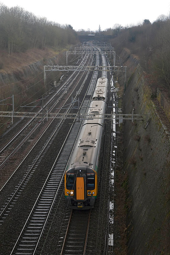 350101, LM 13.46 London Euston-Crewe (1U37, RT), Roade Cutting 
 London Midland 350101 passes through Roade Cutting on the down fast with the 1U37 13.46 Euston to Crewe working. This was a day of sunshine and showers, one of which had just passed. 
 Keywords: 350101 1U37 Roade Cutting