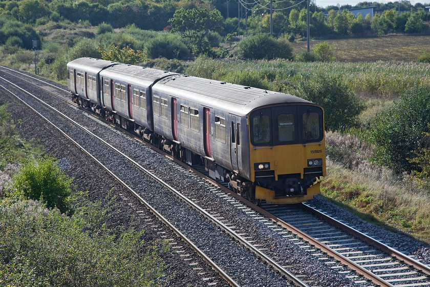 150926, GW 14.59 Frome-Warminster (2F95), Berkley ST802494 
 A strange and rather short working being operated by 150926 is seen passing Berkley just east of Frome. The 14.59 Frome to Warminster working makes the short journey to Westbury where it reverses to then head south to Warminster. Driving by car between the two stations is just over seven miles and would take about fifteen minutes whereas using this train it is over ten miles and takes about thirty minutes. Given this, I presume that it must be some sort of positioning move. 
 Keywords: 150926 14.59 Frome-Warminster 2F95 Berkley ST802494