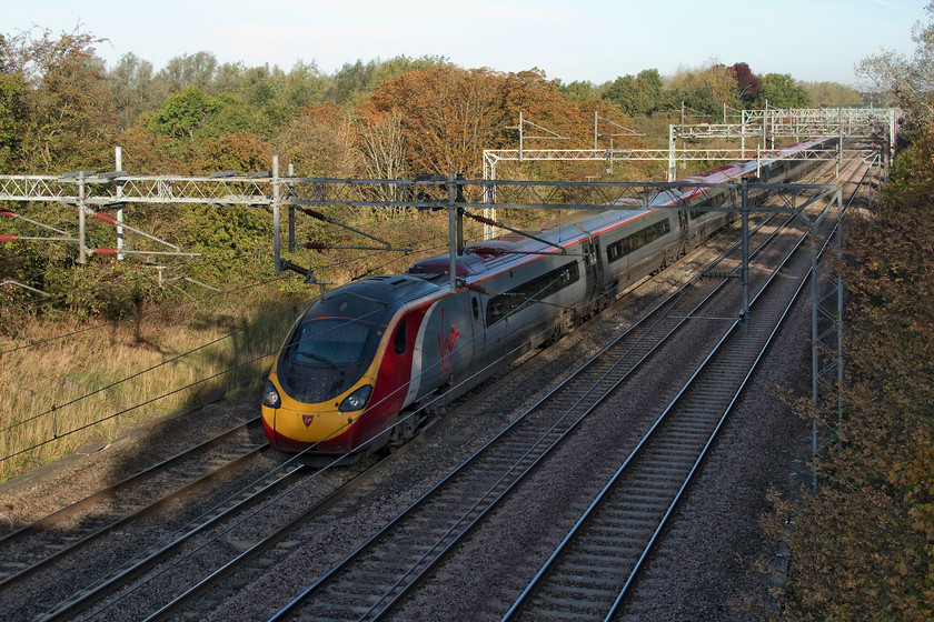 390049, VT 07.15 Manchester Piccadilly-London Euston (1A09, RT), Dansteed Way bridge 
 Taken from Dansteed Way in Milton Keynes, 390049 is slowing for its stop at the station working the 07.15 Manchester to London Euston. There are very few spots around Milton Keynes to photograph trains. All the bridges have huge concrete tops and palisade fencing is everywhere. This is why there are few pictures published taken in this area. 
 Keywords: 390049 1A09 Dansteed Way bridge