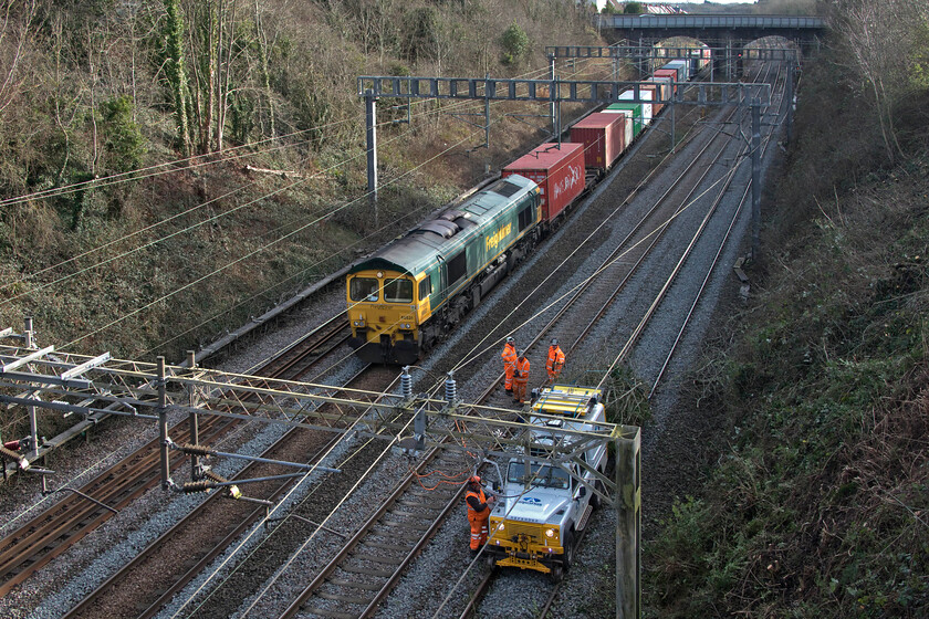 66531, 07.50 Felixstowe North-Lawley Street (4M94, RT), trackworkers & R2R 4x4 multi-purpose road rail vehicle, Hyde Road bridge 
 Whilst another group of track workers appear to be engaged in not very much activity 66531 passes leading the 07.50 Felixstowe to Lawley Street 4M94 Freightliner service. The workers are engaged in clearance of the bank on the right at the same spot back in October where a tree was blown on to the catenary causing a full day of closure of the line, see..... https://www.ontheupfast.com/p/21936chg/30021090637/x66504-12-05-bletchley-relief-bescot. Nothing like acting after the horse has bolted! 
 Keywords: 66531 07.50 Felixstowe North-Lawley Street 4M94 trackworkers & R2R 4x4 multi-purpose road rail vehicle Hyde Road bridgeFreightliner