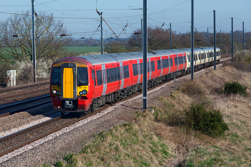 387204 & 387103, GN 09.13 Peterborough-London King's Cross (1P85, 6L), Sandy TL176510 
 With the familiar smiling faces of the Class 365s now gone from this route (and from the entire network for that matter as they have gone to the scrap man!) the rather boring frontage of the Electrostar now is the norm. Some of the units have been procured from various other operators and not yet repainted into GN's house colours as is the case with the leading set in this photograph. 387204 still wears its former Gatwick Express livery as it approaches Sandy on the up slow line with the 09.13 Peterborough to King's Cross service. In its GN livery, 387103 brings up the rear of the service. 
 Keywords: 387204 387103 09.13 Peterborough-London King's Cross 1P85 Sandy TL176510 Great Northern Electrostar