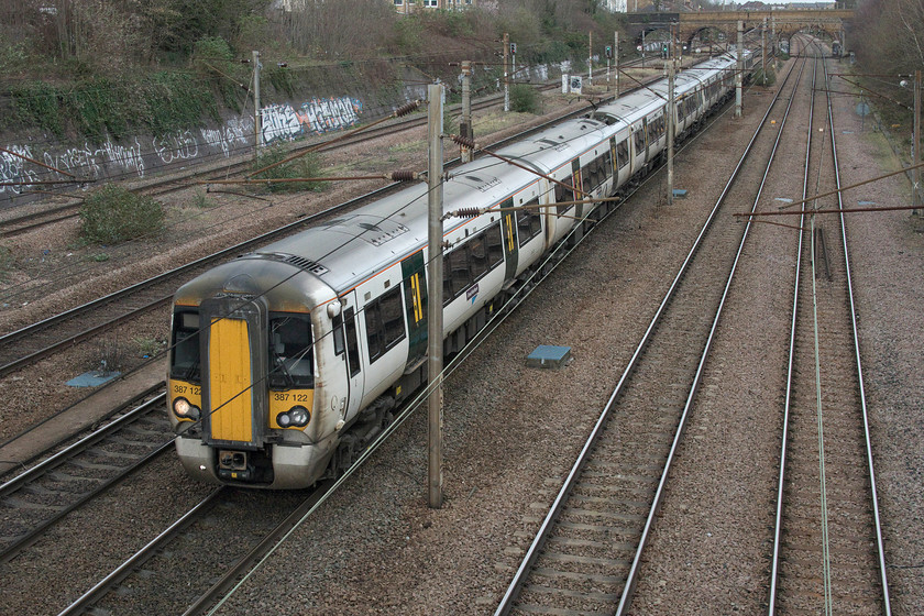 387122, GN 10.47 Ely-London King`s Cross (1T23, 4L), Parkland Walk, Finsbury Park footbridge 
 387122 is seen from the busy footbridge that accesses Finsbury Park from the western side. It is working the 10.47 Ely to King's Cross 1T23 Great Northern service. This footbridge was narrow and busy with people out enjoying some welcome fresh air either in the park or using the Parkland Walk to the western end of the bridge. 
 Keywords: 387122 10.47 Ely-London King`s Cross 1T23 Parkland Walk Finsbury Park footbridge Great Northern Railway