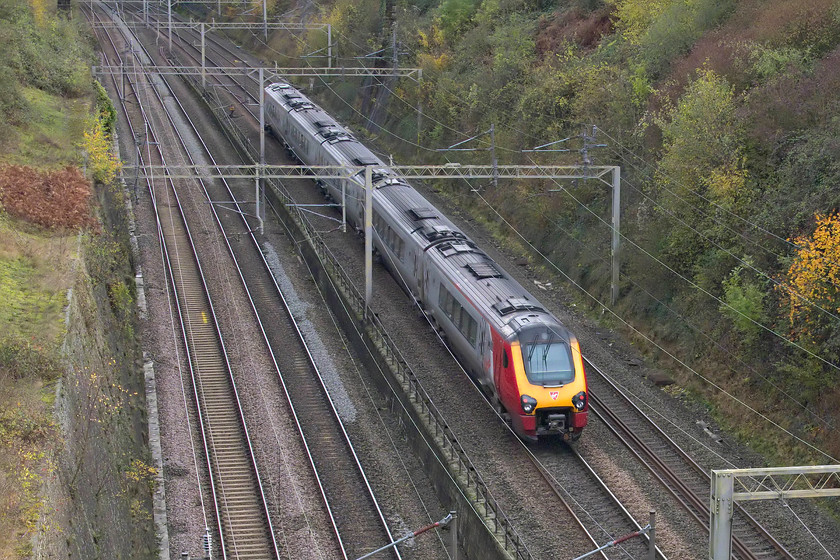 Class 221, VT 12.35 Chester-London Euston (1A35, 7L), Roade cutting 
 An unidentified class 221 is somewhat dwarfed by the magnificence of Roade cutting as it heads south forming the 12.35 Euston to Chester service. Soon the familiar Virgin livery will become a thing of the past as the new operator takes over the WCML services from the start of next month. 
 Keywords: Class 221 12.35 Chester-London Euston 1A35 Roade cutting