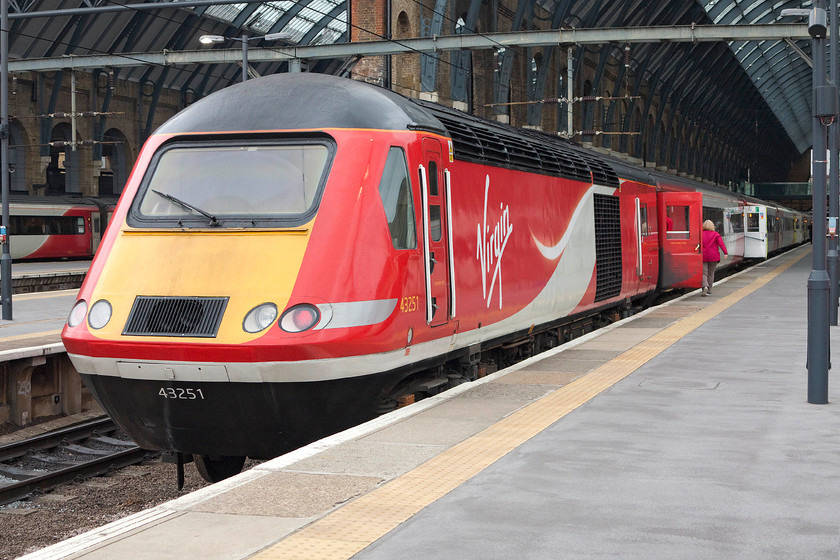 43251, GR unidentified down working, London Kings Cross station 
 43251 looks very smart in it relatively fresh coat of Virgin East Coast red paint with complimentary graphics. Like their class 91 and 82 cousins, the HST look good in this livery. 43251 will lead an unidentified down express. This power car was delivered into service as 43051 as part of Western Region set 253025. 
 Keywords: 43251 down working London Kings Cross station