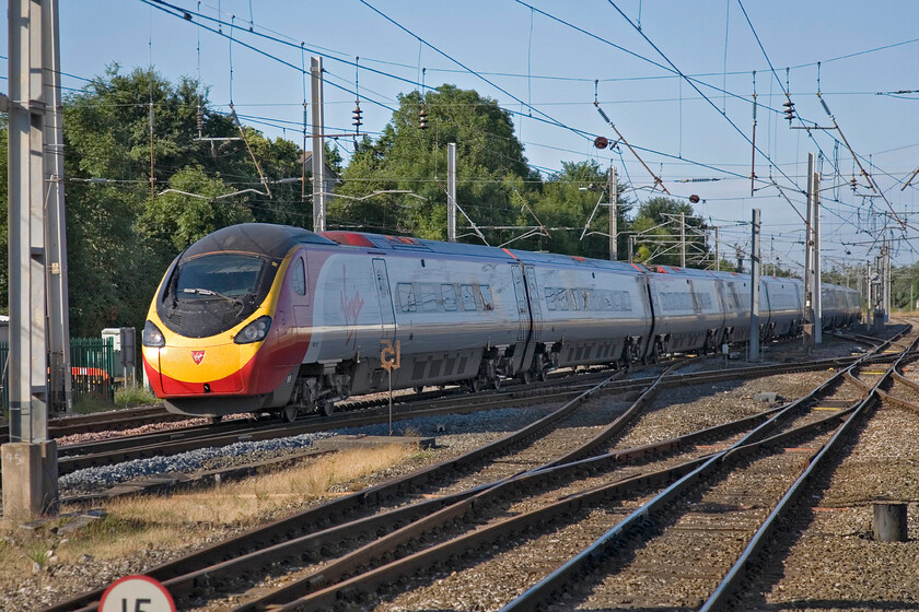 390121, VT 05.39 London Euston-Glasgow Central, Carnforth station 
 390121 passes Carnforth at speed working Virgin Trains' 05.39 Euston to Glasgow Central service. Unfortunately, a bit of a 'grab shot' with the sun on the wrong side of the train. 
 Keywords: 390121 05.39 London Euston-Glasgow Central Carnforth station Virgin West Coast Pendolino Virgin Dream