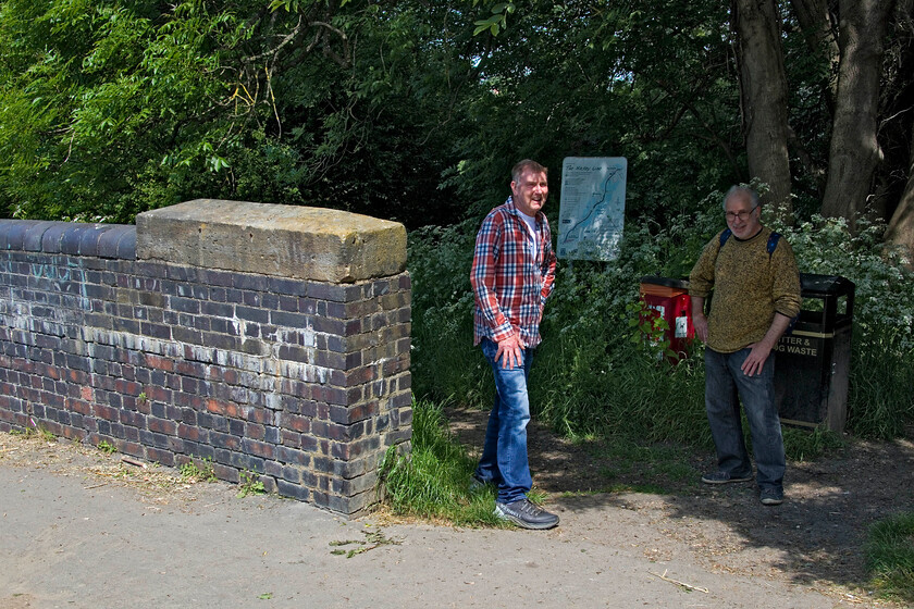 Andy & Mike, end of Nickey Line walk, Midland Road bridge, Hemel Hempstead 
 At the end of our epic walk that took in the length of the Nickey Line from Harpenden to Hemel Hempstead Andy and Mike take a pause on Midland Road in Hemel. To the casual passer by the bridge parapet to the left appears to be a substantial brick wall but to those in the know it is instantly identifiable as a piece of railway infrastucture. The bridge has been filled in and the corresponding parapet on the other side of the road has been removed. 
 Keywords: Andy Mike Nickey Line walk, Midland Road bridge, Hemel Hempstead