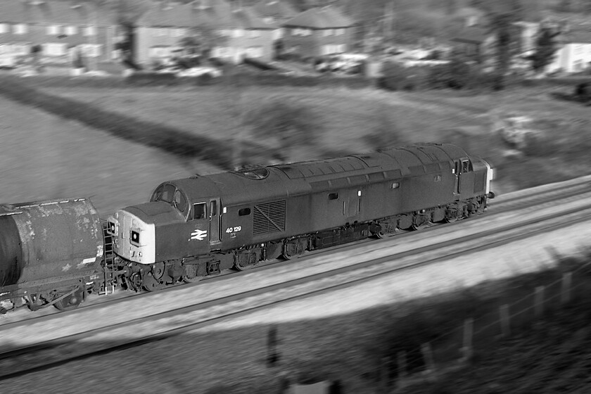 40129, unidentified Severn Tunnel Junction freight, Caerleon ST330923 
 A 'panic' photograph at Ponthir near to Caerleon was taken with no checking of the camera settings and it is one that has actually worked! As we were packing up our kit after the passage of the steam-hauled Welsh Marches Express the unmistakable sound of a Class 40 heralded the passing of what appeared to be a fuel train that ended up at Severn Tunnel Junction as we saw the locomotive again a little later in the afternoon stabled there. The panning technique kept 40129 in relative sharpness with the background exhibiting strong motion blur but it was more down to luck than planning! This split headcode member of the class remained in service until 01.05.84 with it officially withdrawn six weeks later. Cutting up at Doncaster was rapid with it being non-existant by the end of August. 
 Keywords: 40129 Severn Tunnel Junction freight Caerleon ST330923