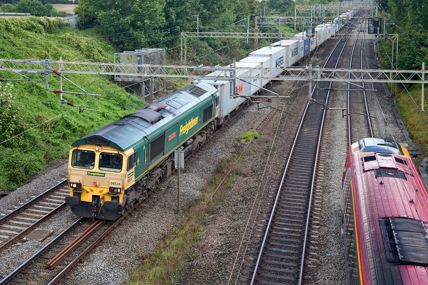 66534, 10.14 Felixstowe-Lawley Street (4M20) & class 221, VT 14.23 London Euston-Birmingham New Street (9G26, 23L), Victoria Bridge 
 66534 'OOCL Express' brings the 10.14 Felixstowe to Lawley Street Freightliner past Victoria Bridge. Meanwhile, an unidentified class 221 speeds south forming the 14.23 Birmingham new Street to London Euston. 
 Keywords: 66534 10.14 Felixstowe-Lawley Street 4M20 class 221 VT 14.23 London Euston-Birmingham New Street 9G26 Victoria Bridge