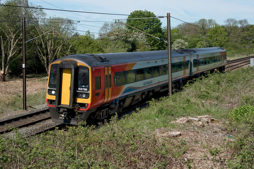 158788, EM 07.42 Liverpool Lime Street-Norwich (1L06, 6L), High Dyke SK942289 
 There is a reason for taking this picture that is totally the wrong side for the sun, and it's this..... https://www.ontheupfast.com/v/photos/21936chg/25410350604/x55018-10-55-leeds-london-kings-cross The Deltic is seen in August 1978 passing the same spot even though the angle is slightly different due to the modern day restrictions imposed by palisade fencing. East Midlands 158788 is working the 07.42 Liverpool Lime Street to Norwich past High Dyke on the northern approach to Stoke tunnel. The flat area in the background that is now covered by trees used to be the location of the High Dyke sidings that handled wagons from the nearby ironstone workings towards Colsterworth. 
 Keywords: 158788 07.42 Liverpool Lime Street-Norwich 1L06 High Dyke SK942289