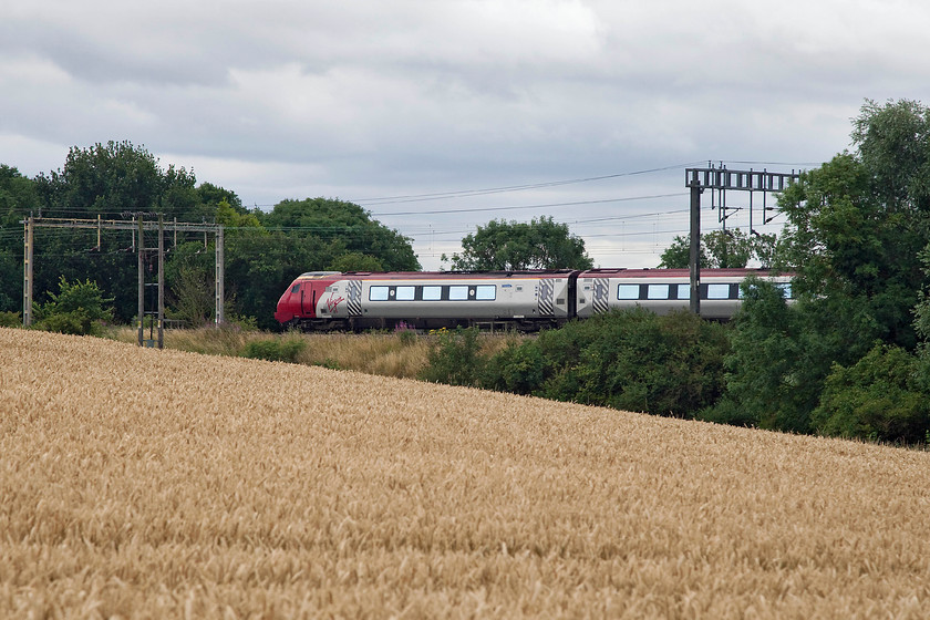 Class 221, VT 11.28 Chester-London Euston (1A19, 6E), Roade Hill 
 With the wheat just a couple of weeks off harvest it adds a lovely golden glow to the countryside that certainly brightens up an otherwise dull summer afternoon! Here at Roade Hill, just across the field from home, a class 221 heads south with the 11.28 Chester to London Euston. The passengers will be arriving into London in about 25 minutes and, in this case, about six minutes early. 
 Keywords: Class 221 1A19 Roade Hill