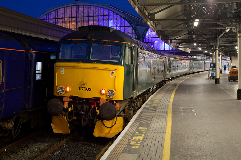 57602, GW 23.45 London Paddington-Penzance Sleeper (1C99, 2E), London Paddington station 
 57602 'Restormel Castle' stands at the head of the 23.45 Paddington to Penzance Night Rivera Sleeper. This was our train westwards for the night and just how excited were we? I love the lighting in this image from the midsummer dark sky, the purple colouring in the train shed to the bright and clean platform illumination. It's all been picked up so well by the camera and all handheld, modern digital equipment is amazing! 
 Keywords: 57602 23.45 London Paddington-Penzance Sleeper 1C99 London Paddington station