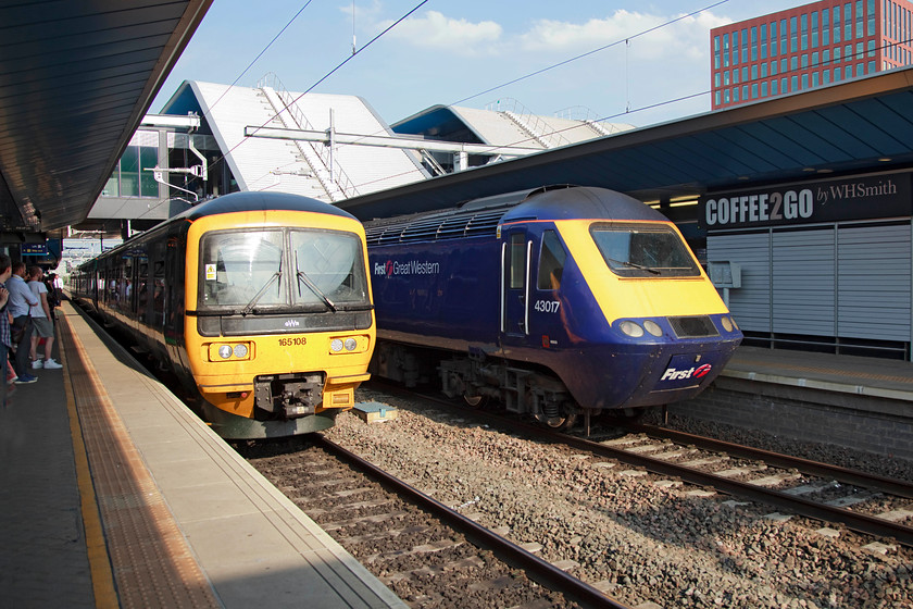 165108, GW 17.18 London Paddington-Oxford (1D35, 7L) & 43017, GW 16.30 Bristol Temple Meads-London Paddington (1A25), Reading station 
 165108 draws into Reading station working the 17.18 Paddington to Oxford 'stopper' train. Next to it is the rear of the 1A25 16.30 Bristol to Paddington with 43017 providing the power. 43017 was an early Western Region power car that was part of set 253008. Andy and I travelled in the incredibly hot and busy Turbostar as far as Tilehurst. 
 Keywords: 165108 1D35 43017 1A25 Reading station