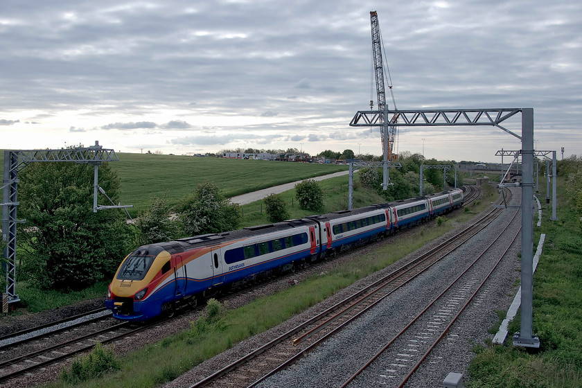 222009, EM 17.00 Sheffield-London St. Pancras (1C67, 1L), Irchester SP927667 
 In very different weather and light to yesterday's crisp blue and clear skies, 222009 heads south with the 17.00 Sheffield to St. Pancras working. I took this picture at Irchester, just south of Wellingborough in order to demonstrate the huge crane being used by the contractors installing a new bridge for the westbound A45 who's temporary access road crosses the field directly behind the train. Since my last visit in October 2018, the scene has changed very little indicating that progress remains a little slow..... https://www.ontheupfast.com/v/photos/21936chg/25047595204/x222018-12-00-sheffield-london-st 
 Keywords: 222009 17.00 Sheffield-London St. Pancras 1C67 Irchester SP927667