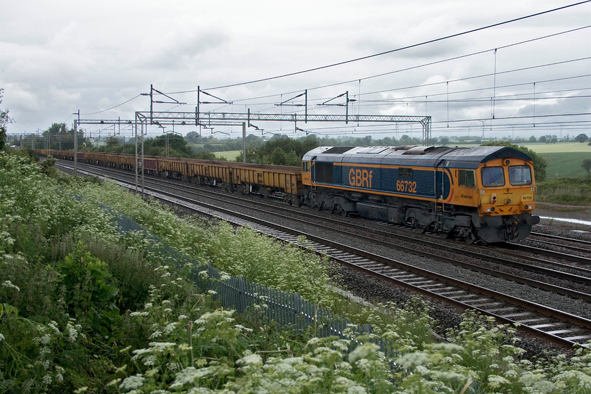 66732, 10.00 Willesden West London Junction-Bescot up engineers (7G52, 2L), Gordon`s Lodge 
 In the pouring rain and terrible lighting 66732 'GBRf The First Decade 1999-2009 John Smith MD' trails along at the rear of the 7G52 10.00 Willesden to Bescot engineering train. This is my first photograph of this particular Class 66 on the mainline with my only other images being when it operated on the Nene Valley Railway in 2009 being less than a year old. 
 Keywords: 66732 10.00 Willesden West London Junction-Bescot up engineers 7G52 Gordon`s Lodge engineering train GBRf The First Decade 1999-2009 John Smith MD