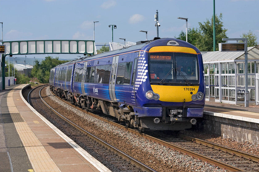 170394, SR 12.58 Dunblane-Edinburgh Waverley (2P86), Camelon station 
 Camelon Station is located in the north-western suburb of Falkirk and, indeed, its first station that closed 04.09.67 was named Falkirk (Camelon). The present-day station is a short distance west of the first one and opened in 1994. 170394 arrives with the ScotRail 12.58 Dunblane to Edinburgh service. In the next few years services are to be transformed with the arrival of electrification and new units operating the frequent services. 
 Keywords: 170394 12.58 Dunblane-Edinburgh Waverley 2P86 Camelon station ScotRail