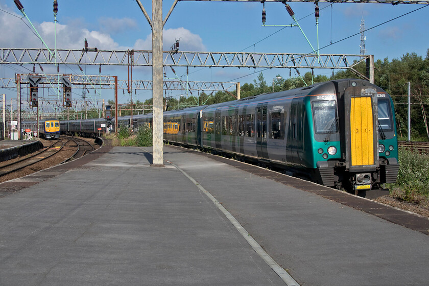 319385, NT 16.56 Wigan North Western-Liverpool Lime Street (2C22, RT) & 350369 LN 16.04 Birmingham New Street-Liverpool Lime Street (1F50, RT), Edge Hill station 
 At the eastern end of Edge Hill station London North Western's 350369 with another unit at the rear passes with the 16.04 Birmingham New Street to Liverpool Lime Street service. Meanwhile, 319385 approaches working the 16.56 Wigan North Western to Lime Street Northern service. 
 Keywords: 319385 16.56 Wigan North Western-Liverpool Lime Street 2C22 350369 16.04 Birmingham New Street-Liverpool Lime Street 1F50 Edge Hill station Northern London North Western Desiro