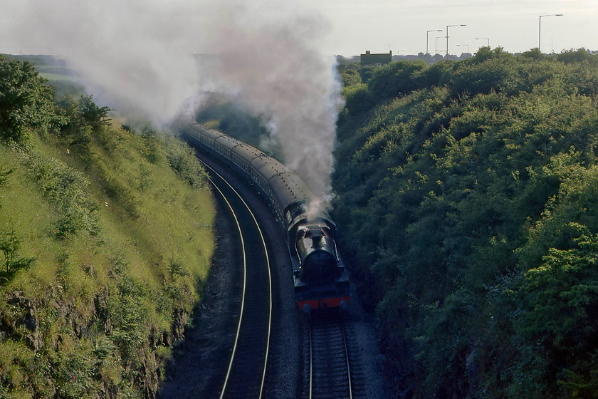 5690 return leg of The Cumbrian Coast Express, 16.45 Sellafield-Blackpool North, Lindal bank SD240747 
 Quite why we chose to see the return of The Cumbrian Coast Express railtour here at LindaI am not too sure? As it was in a cutting and into the light it cannot have been for the picture, perhaps, as it was climbing steeply here, it was for the sound as Graham was an avid audio recorder and cin filmer. 5690 'Leander' is working hard leading the thirteen coach train that left Sellafield at 16.45 ending up at Carnforth with 40143 taking the train on to Blackpool North. 
 Keywords: 5690 The Cumbrian Coast Express 16.45 Sellafield-Blackpool North Lindal bank SD240747