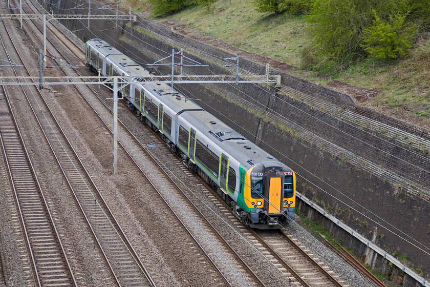 350122, LM 11.14 Birmingham New Sreet-London Euston, Roade cutting 
 The 11.14 Birmingham to Euston London Midland service passes through Roade cutting worked by 350122. There is talk that from the summer timetable next month that nearly all of the services between Birmingham and Euston will be worked by twin sets of Desiros as overcrowding on these four-car trains is becoming a problem. 
 Keywords: 350122 11.14 Birmingham New Sreet-London Euston, Roade cutting London Midland Desiro