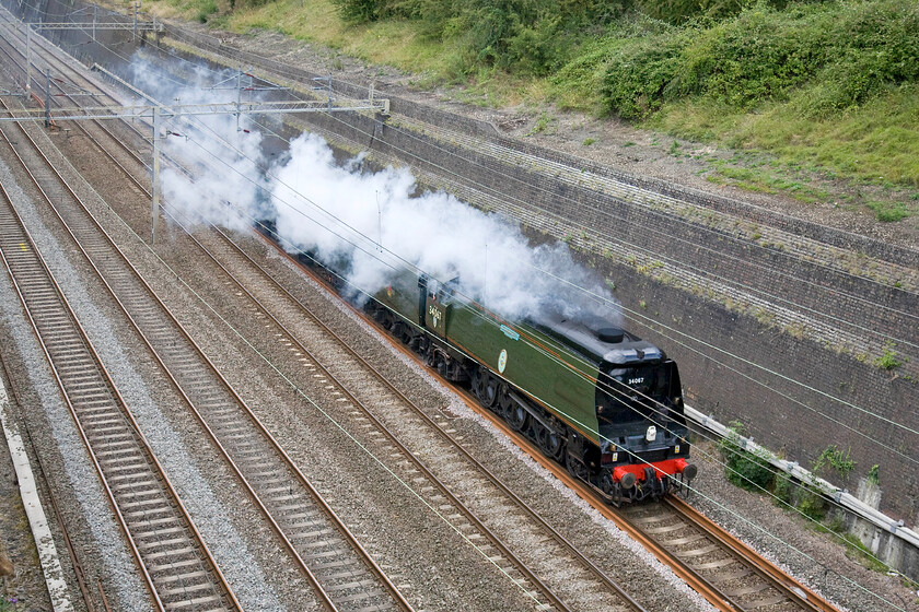 34067, 07.20 Carnforth-Southall (5Z42), Roade cutting 
 Former Southern Railway's 34067 'Tangmere' passes light engine through Roade cutting running as 5Z42. The 4-6-2 Pacific Class was one of forty introduced between 1945 and 1951 that worked throughout their life on the Southern Region. The 07.20 Carnforth to Southall move was in order for Tangmere to be one of the locomotives to haul the railway Touring Company The Dorset Coast Express the following day. However, the charter was canceled at short notice due to fire brigade union industrial action. 
 Keywords: 34067 07.20 Carnforth-Southall 5Z42 Roade cutting Tangmere