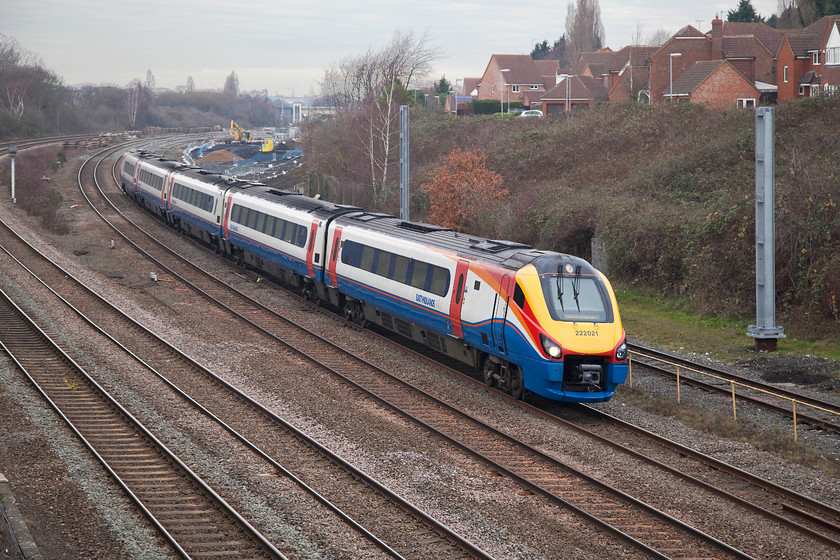 222021, EM 12.41 Corby-London St. Pancras (1P17, 3L), Headlands bridge 
 Seen a short time earlier on its outward journey, 222021 is now returning to St. Pancras forming the 1P17 12.41 from Corby. In the background is Ostlers Way, many of its houses offer commanding views of the busy Midland Mainline that should soon become somewhat quieter as electric trains are introduced on the Corby services such as this one. 
 Keywords: 222021 12.41 Corby-London St. Pancras 1P17 Headlands bridge