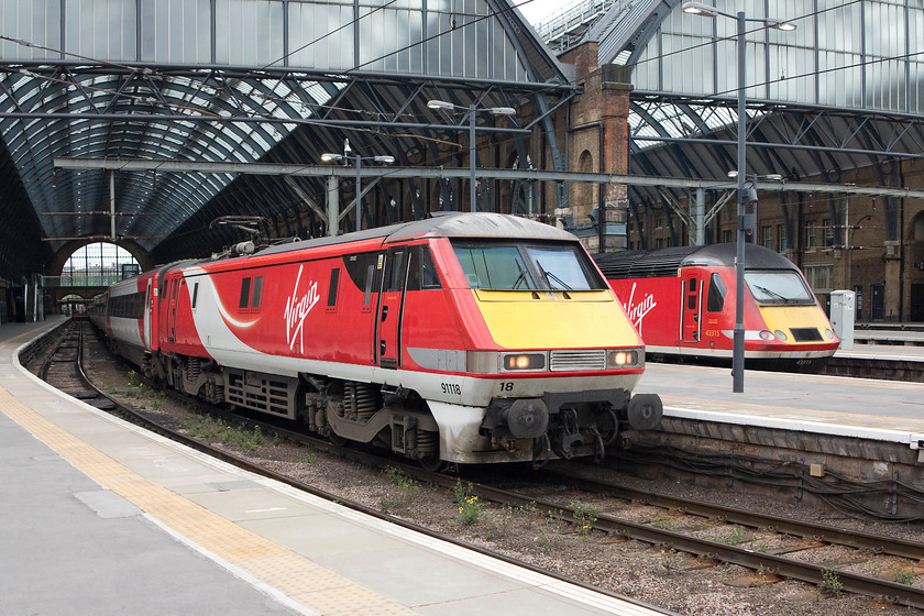 91118, GR 16.33 Kings Cross-Leeds (1D22, 20L) & 43315, GR 17.00 London Kings Cross-Edinburgh (1S26, 14L), London Kings Cross station 
 91118 waits at the head of the 16.33 to Leeds whilst 43315 heads the 17.00 HST service to Edinburgh. Would I prefer to travel in a Mk.IV behind a powerful electric locomotive or in the classic environment of a Mk.III HST coach? If I'm honest, I would not care as long as it was not a modern 'plastic' train where the seats don't line up with the windows and the seating is more akin to a cramped Easyjet flight! 
 Keywords: 91118 1D22 43315 1S26, London Kings Cross station