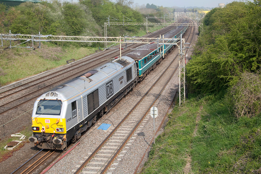 67029, 09.01 London Euston-Atherstone (1Z95), Victoria bridge 
 67029 'Royal Diamond' brings up the rear of the 1Z95 09.01 Euston to Atherstone charter. It is seen passing Victoria bridge near to Roade in Northamptonshire with 90035 up front. I never have discovered what this excursion was for....any help appreciated! 
 Keywords: 67029 09.01 London Euston-Atherstone 1Z95 Victoria bridge