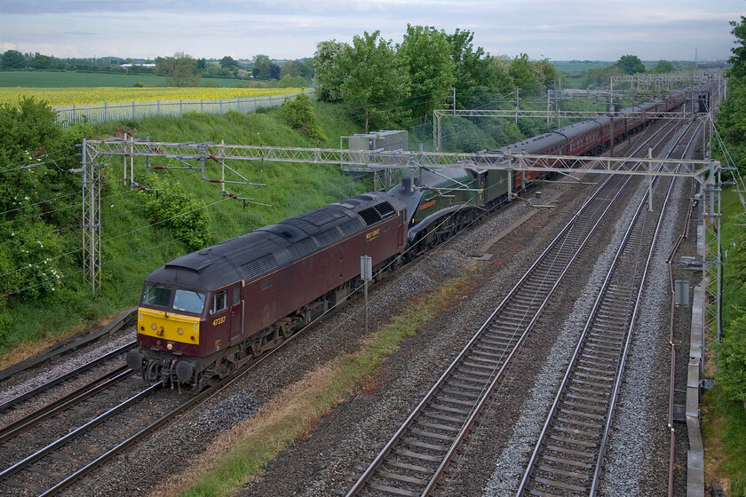 47237 & 60009, 14.30 Southall-Kidderminster (5Z64), Victoria bridge 
 I have not judged this photograph quite correctly both in terms of the chosen spot and the actual positioning of the train! I had intended that both the piloting Class 47 and 60009 'Union of South Africa' should fit between the electrification masts but I have managed to clip the steam locomotive slightly! The empty coaching stock, running as 5Z64, left WCR's Southall base at 14.30 and was heading to the SVR at Kidderminster. The train is seen passing Victoria bridge just south of Roade in Northamptonshire. 
 Keywords: 47237 60009 14.30 Southall-Kidderminster 5Z64 Victoria bridge Union of South Africa West Coast Railways WCR