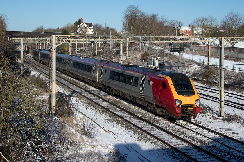 221106, VT 07.54 Blackpool North-London Euston (9M48, 2L), site of Roade station 
 Passing the site of Roade station 221106 'Willem Barents' makes a fine site still wearing its Virgin West Coast livery over a year after the operator ceased its operations. Unusually, this diesel Voyager was working the 07.54 Blackpool to Euston service. Now that the line to the resort town is fully electrified services such as this ought to be formed by a Pendolino with many spare sets surely available due to the massively reduced working timetable. 
 Keywords: 221106 07.54 Blackpool North-London Euston 9M48 site of Roade station Virgin Voyager Avanti West Coast Willem Barents