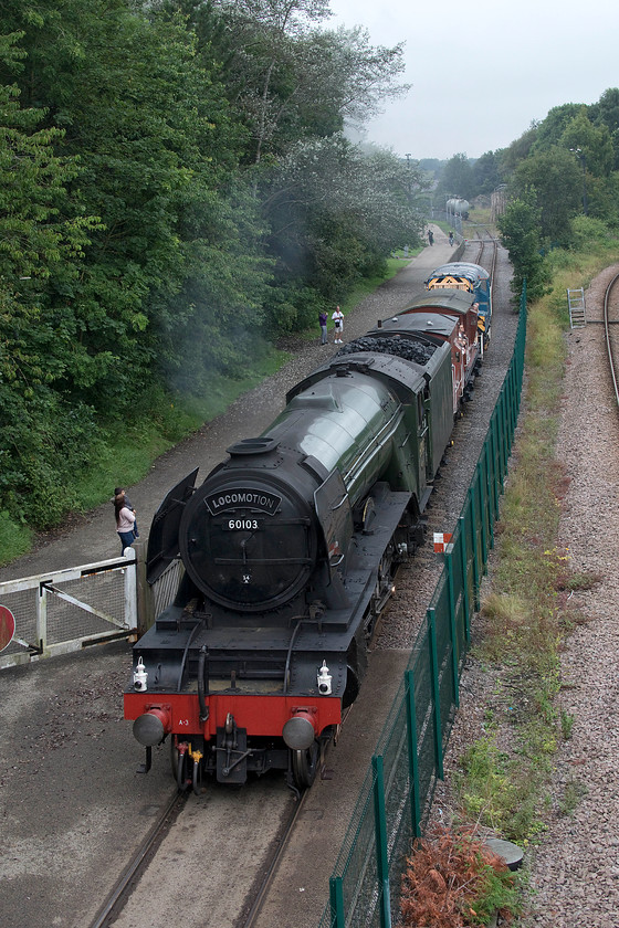 60103, demonstration train, Shildon 
 With very few observers about, unlike the crazy scenes out on the mainline, 60103 'Flying Scotsman' brings a short train down the Locomotion Museum's demonstration track at Shildon. The brake vans behind the locomotive were packed with museum visitors who had queued for quite some time to do so. At the back of the short train was 09911 'Matey' giving some assistance on the outward run. 
 Keywords: 60103 demonstration train Shildon