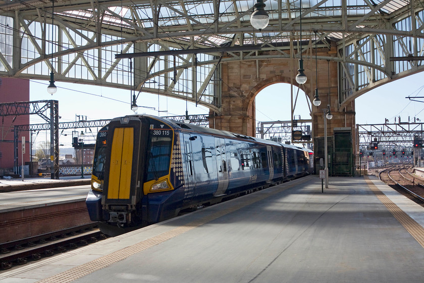 380115, SR 10.08 Gourock-Glasgow Central (2G26), Glasgow Central station 
 380115 enters Glasgow Central station with the 2G26 10.08 from Gourock. This image clearly shows off the glazing that makes up the entire roof of Central station making it the light and airy place that it is. In 1998 Railtrack embarked on a five-year reconstruction programme when the whole roof was removed and re-glazed. 
 Keywords: 380115 10.08 Gourock-Glasgow Central 2G26 Glasgow Central station