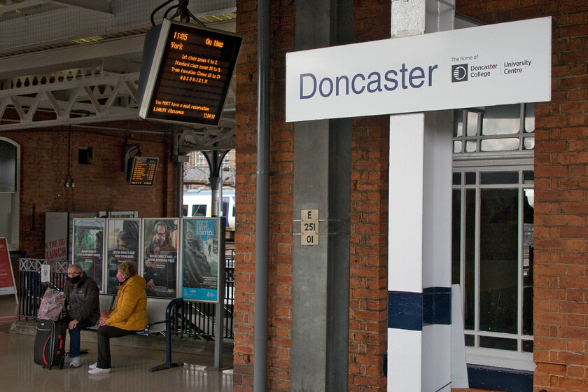 Rail travel COVID style, Doncaster station 
 Notices, masks and quiet stations are somethings that we have all become used to since the pandemic took over our respective worlds during the spring of 2020. Here at a chilly Doncaster these situations are personified as with the few passengers present waiting for their trains. 
 Keywords: Rail travel COVID style Doncaster station