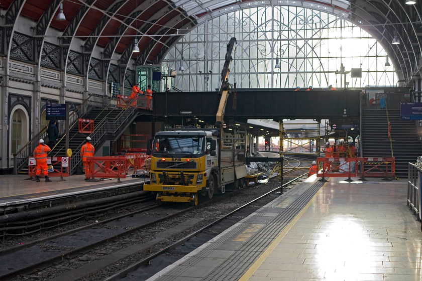 Electrification work, London Paddington station 
 Work is underway to raise the passenger footbridge over platforms one and two at Paddington in order to facilitate the electrification equipment. I always find it quite extraordinary watching the workers at 'work' with the amount of time spent standing around, usually on their mobile 'phones, is extraordinary! This image is a good example. How many staff are there in this image and how many are actually doing anything? No wonder that there is so much disruption on the railways due to 'engineering works'! 
 Keywords: Electrification work London Paddington station