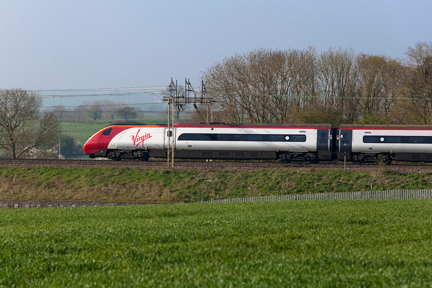 390107, VT 07.48 Liverpool Lime Street-London Euston (1A12, 1L), between Roade & Ashton 
 The front power car of the 07.48 Liverpool Lime Street to London Euston worked by set 390107 'Independence Day Resurgence' passes through the spring countryside between Roade and Ashton on the southern WCML. 
 Keywords: 390107 1A12 between Roade & Ashton