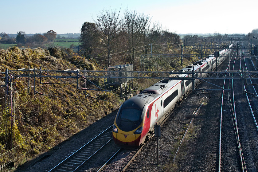 390136, VT 10.45 London Euston-Glasgow Central (1S58, 1E), Victoria bridge 
 390136 'City of Coventry' forms the 10.45 Euston to Glasgow Central 1S85 past Victoria bridge just south of Roade in Northamptonshire. The more observant will notice that the Pendolino is on the down slow line. As the Weedon Loop was closed for engineering works, all trains were being diverted via Northampton. 
 Keywords: 390136 10.45 London Euston-Glasgow Central 1S58 Victoria bridge