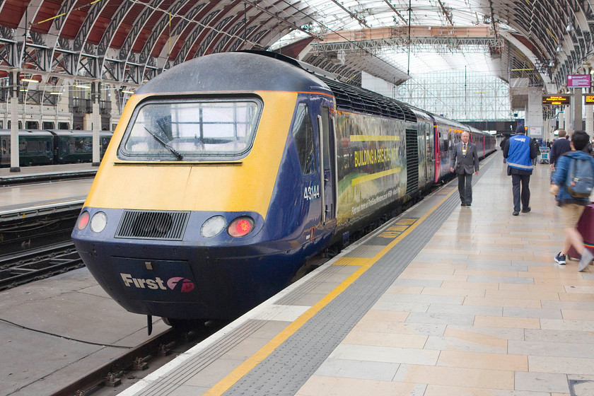 43144, GW 10.01 Pembroke Dock-London Paddington (1L62), London Paddington station 
 43144 waits to leave Paddington station with the 10.01 to Pembroke Dock. This 260 mile journey is one of contrast. After travelling along Brunel's famous billiard table line at full service speed, the train plunges under the River Severn. It continues fast through South Wales then making much more sedate progress though to West Wales passing through absolute block signalling and travelling on jointed track. I could not think of a better way to do this than in an the comfort and space of a Mk. III HST coach. I hope the the new trains being introduced in the next few years are a worthy replacement. 
 Keywords: 43144 10.01 Pembroke Dock-London Paddington 1L62 London Paddington station