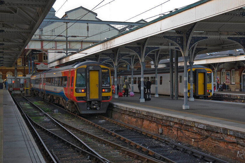 158862, EM 16.57 Norwich-Manchester Piccadilly (1R60) & 156412, LE 16.40 Norwich-Great Yarmouth (2P28), Norwich station 
 Within the hour 158862 will leave Norwich with the 16.57 to manchester Piccadilly. Most of these East Midland Railway services extend to Liverpool but a couple a day terminate and start from Piccadilly. To the right, 156412 will depart slightly earlier with the 2P28 local 'all stations' to Great Yarmouth via Acle. 
 Keywords: 158862 16.57 Norwich-Manchester Piccadilly 1R60 156412 16.40 Norwich-Great Yarmouth 2P28 Norwich station