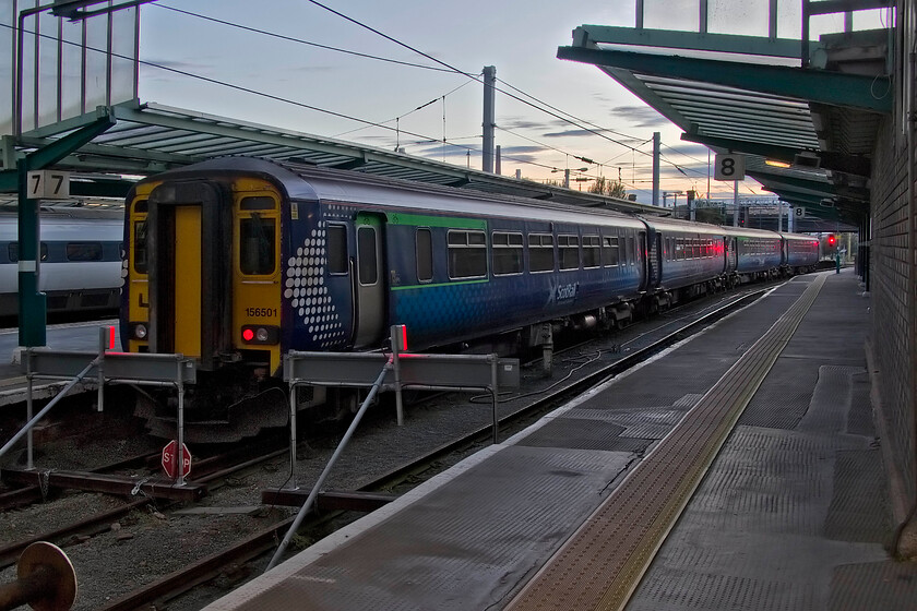 156501 & 156462, SR 23.10 Carlisle-Dumfries (2L74, 4E), Carlisle station 
 156501 and 156462 sit at Carlisle's platform seven to work the 23.10 service to Dumfries later in the evening. I love photographing in these sorts of conditions that provide its own challenges making the user use the camera's function creatively. However, the Canon G1x, that is my normal 'go-to' camera had started to play up not writing the images to the card despite my trying an alternative one. It was a good job that I had by 5D Mk. II with me as a backup! 
 Keywords: 156501 156462 23.10 Carlisle-Dumfries 2L74 Carlisle station ScotRail