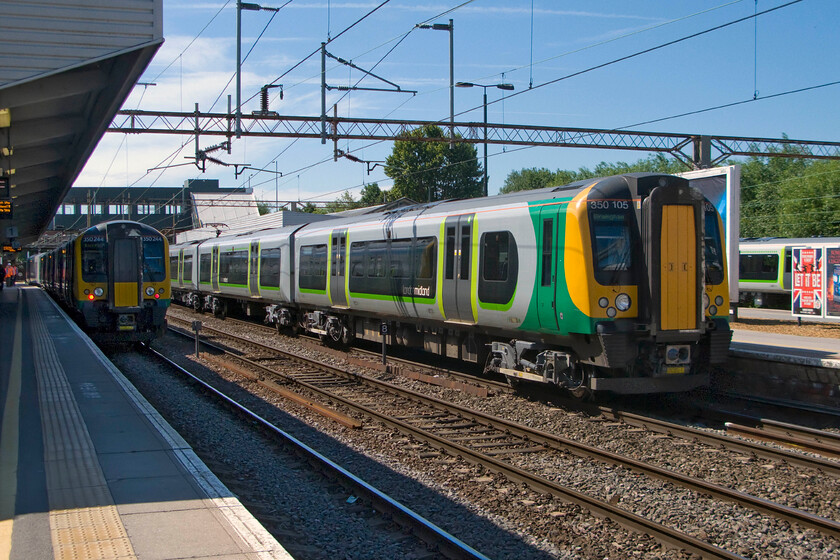 350244, LM 09.33 Birmingham New Street-London Euston (1W08) & 350105, LM 09.49 London Euston-Birmingham New Street (1W07), Northampton station 
 Two London Midland Desiros pause at Northampton station. To the left 350244 is working the 09.33 Birmingham New Street to Euston 1W08 service whist 350105 pauses with the 09.49 Euston to New Street train. This is a common scene at Northampton with these unit operating virtually all of these local services between the two cities. 
 Keywords: 350244 09.33 Birmingham New Street-London Euston 1W08 350105 09.49 London Euston-Birmingham New Street 1W07 Northampton station London Midland Desiro