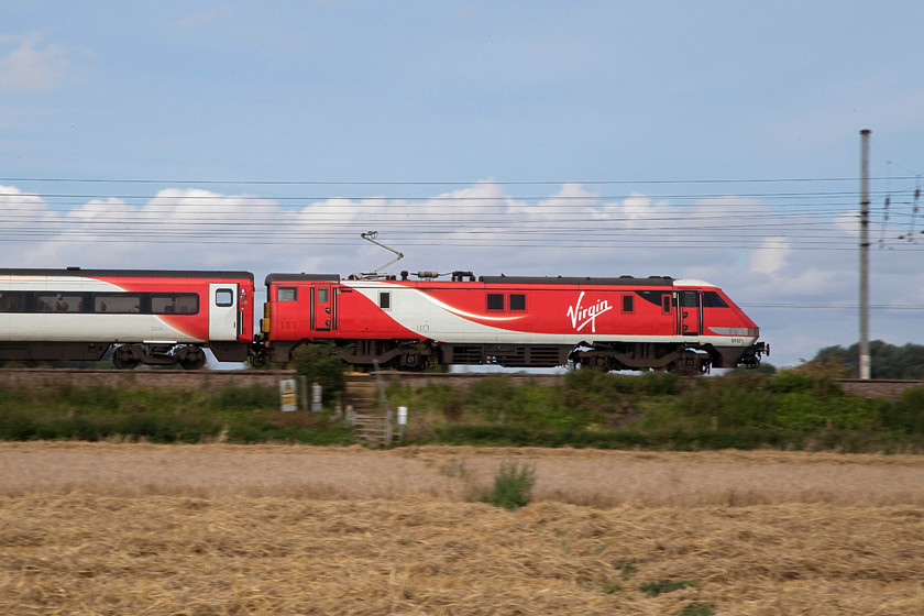 91121, GN 09.16 Leeds-London Kings Cross (1A19, RT), Holme Green TL193422 
 A photograph that clearly shows the different shape of the ends of a class 91. Running sharp end it will do up to 140mph (125mph service speed) but if running blunt end first (that does occasionally happen) it is limited to 110mph. In this picture, 91121 is pushing the 09.16 Leeds to King's Cross past Holmes Green in south Bedfordshire. 
 Keywords: 91121 1A19 Holme Green TL193422