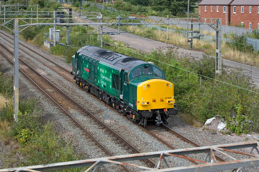 37608, 12.28 Derby RTC-Wembley Yard (0H72, RT), site of Roade station 
 Namer 2 - 37608 'Andromeda'

Resplendent in its new Rail Operations Group livery veteran 37608 'Andromeda' passes through Roade. It was travelling as the 0H72 12.28 Derby RTC to Wembley Yard no doubt in preparations for some stock move or other. 37608 is considerably older than me dating from 1961, at sixty-three years old it still maintains its good looks; it's a shame that I do not! 
 Keywords: 37608 12.28 Derby RTC-Wembley Yard 0H72 site of Roade station