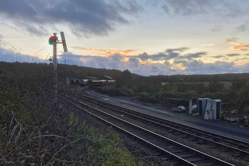 Weybourne yard 
 Silhouetted against a dramatic early evening sky at Weybourne is its up starter pulled off as operations have finished for the day and the signalman has switched everything out. In the adjacent yard is one of the railway's resident Class 101 DMUs. This is one of my favourite stations and I was very disappointed to find it shut due to COVID management during our stay in Norfolk. 
 Keywords: Weybourne yard GN Great Northern Sumersault signal