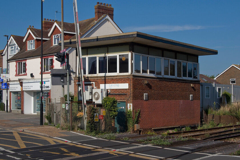 Lancing signal box (BR, 1963) 
 Like Littlehampton, that I visited yesterday, Lancing box seen here should be closed by now with full control moving the Three Bridges regional operation centre. However, both are still operational, in the case of the former still controlling semaphores! I am not quite sure what role Lancing box still plays but it did have a Westinghouse M5 entrance-exit signalling panel commissioned and installed in 1988. The box was built in 1963 replacing a mechanical box on the opposite of the line. The roof is not original as it was blown off during the 'Great Storm' of 1987. 
 Keywords: Lancing signal box Britsh Railways